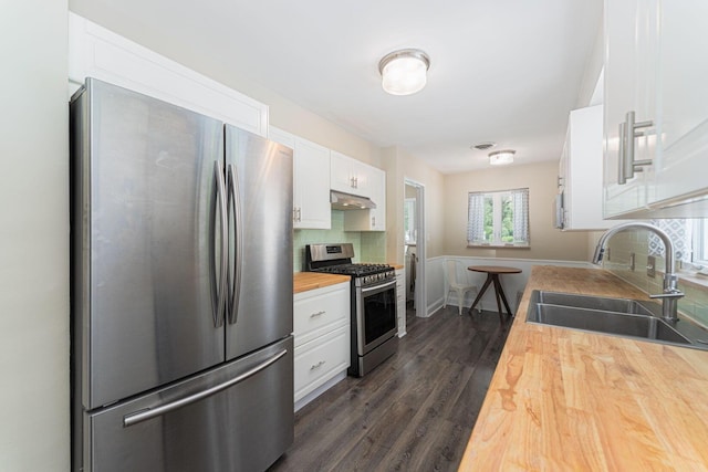 205 Meadowlark Ln, Columbus, OH 43214 - kitchen featuring stainless steel appliances, wood counters, a sink, white cabinetry, and dark wood-style floors