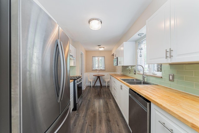 205 Meadowlark Ln, Columbus, OH 43214 - kitchen with appliances with stainless steel finishes, a sink, wood counters, and tasteful backsplash