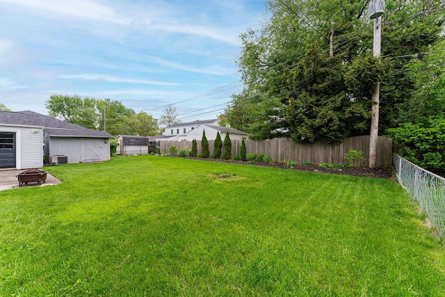 205 Meadowlark Ln, Columbus, OH 43214 - view of yard featuring a fire pit, central AC, an outdoor structure, and a shed