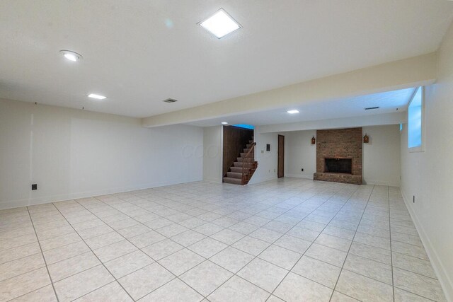 735 Cherrington Rd, Westerville, OH 43081 - finished basement featuring a brick fireplace, stairway, light tile patterned floors, recessed lighting, and baseboards