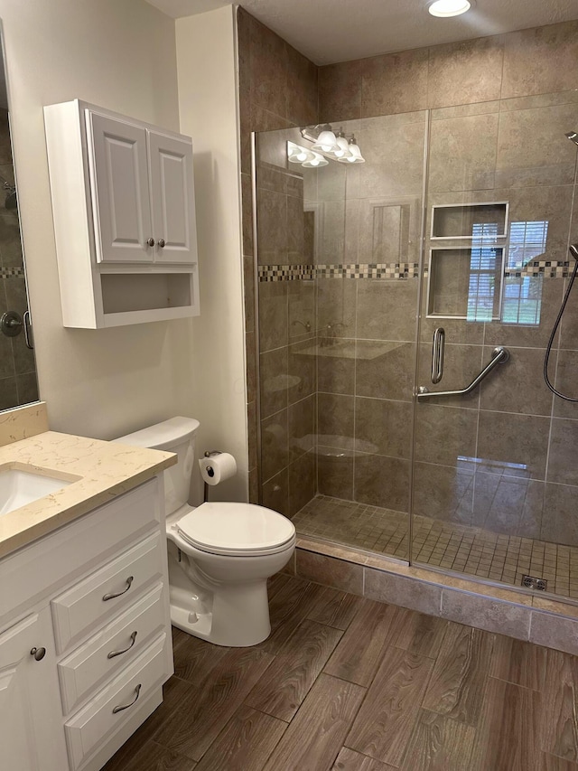 6667 Heatherstone Loop, Dublin, OH 43017 - full bath with a stall shower, toilet, vanity, and wood finished floors