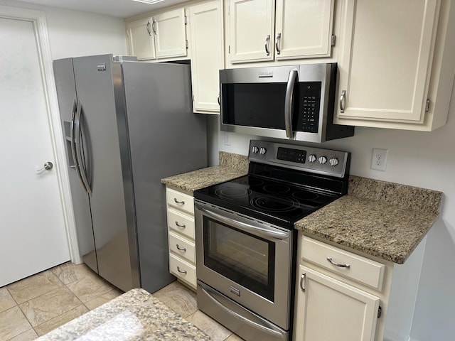 6667 Heatherstone Loop, Dublin, OH 43017 - kitchen with appliances with stainless steel finishes, light stone counters, and white cabinets