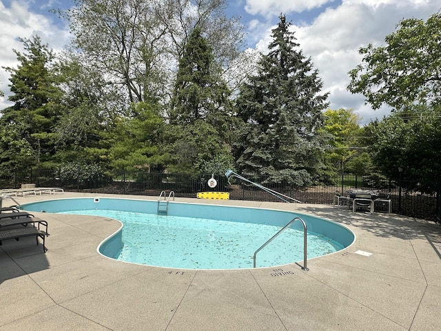 6667 Heatherstone Loop, Dublin, OH 43017 - community pool featuring fence, a patio, and view of wooded area