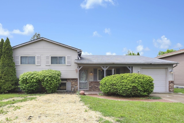 1703 Ringfield Dr, Galloway, OH 43119 - split level home with a garage, driveway, brick siding, and a front yard