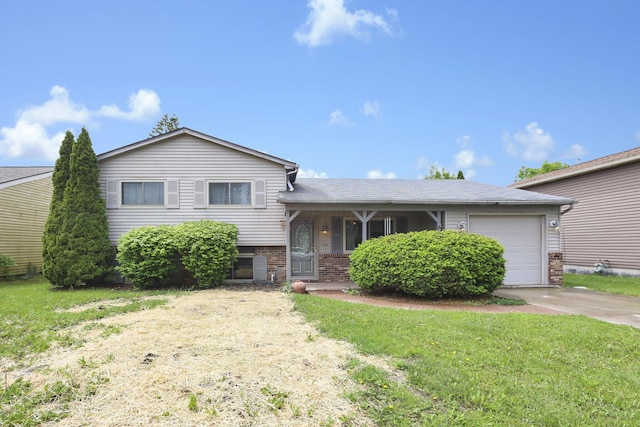 1703 Ringfield Dr, Galloway, OH 43119 - split level home with driveway, an attached garage, a front lawn, and brick siding
