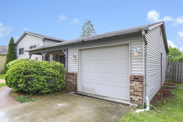 1703 Ringfield Dr, Galloway, OH 43119 - view of front facade featuring brick siding, fence, an attached garage, and driveway