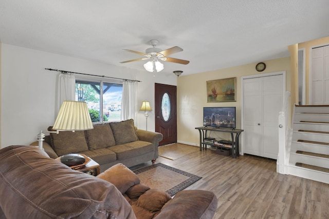 1703 Ringfield Dr, Galloway, OH 43119 - living room with stairway, wood finished floors, a ceiling fan, and baseboards