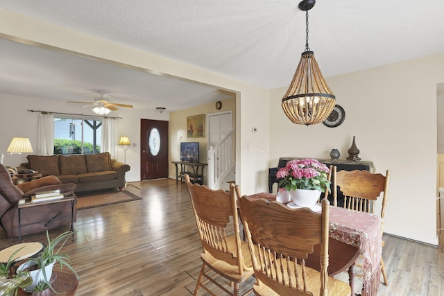 1703 Ringfield Dr, Galloway, OH 43119 - dining area featuring stairway, a chandelier, wood finished floors, a ceiling fan, and a textured ceiling
