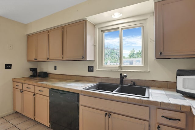 1703 Ringfield Dr, Galloway, OH 43119 - kitchen with black dishwasher, a sink, tile counters, white microwave, and light tile patterned floors