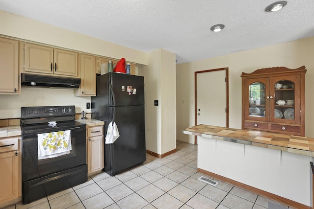 1703 Ringfield Dr, Galloway, OH 43119 - kitchen featuring black appliances, under cabinet range hood, tile counters, light tile patterned flooring, and a textured ceiling