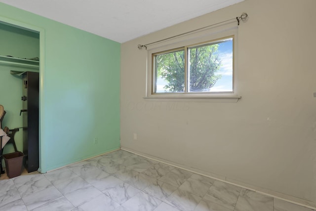 1703 Ringfield Dr, Galloway, OH 43119 - unfurnished bedroom featuring light marble finish flooring and baseboards