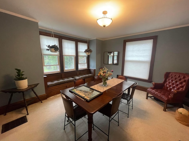 91 Oakland Park Ave, Columbus, OH 43214 - dining area featuring crown molding, baseboards, and light colored carpet