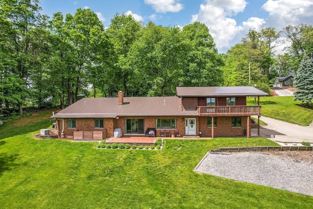 8485 Benson Rd NW, Carroll, OH 43112 - back of property featuring a patio area, a chimney, metal roof, brick siding, and a wooden deck
