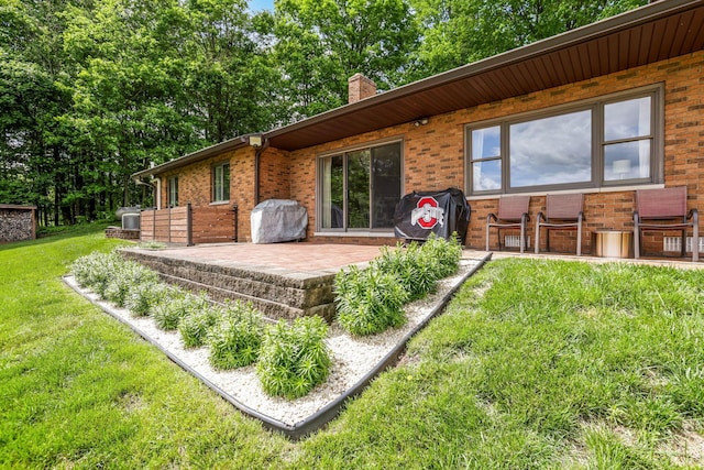 8485 Benson Rd NW, Carroll, OH 43112 - back of property with brick siding, a lawn, a patio, and a chimney