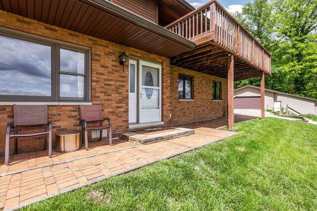8485 Benson Rd NW, Carroll, OH 43112 - view of exterior entry with brick siding, a yard, a deck, and a patio area