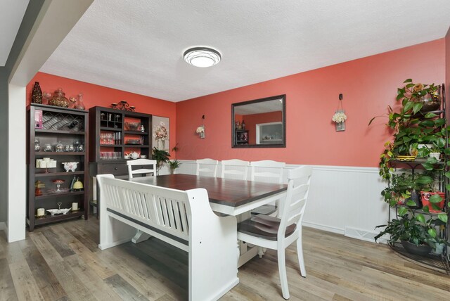8485 Benson Rd NW, Carroll, OH 43112 - dining room with wainscoting, wood finished floors, and a textured ceiling