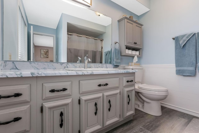 8485 Benson Rd NW, Carroll, OH 43112 - full bath featuring toilet, wood finished floors, a wainscoted wall, vanity, and a shower with curtain