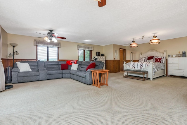 8485 Benson Rd NW, Carroll, OH 43112 - living area with carpet flooring, a wainscoted wall, ceiling fan, wood walls, and a textured ceiling