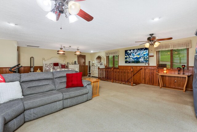 8485 Benson Rd NW, Carroll, OH 43112 - living room featuring ceiling fan, wainscoting, carpet, wood walls, and arched walkways