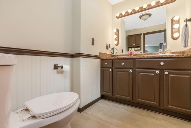 8485 Benson Rd NW, Carroll, OH 43112 - bathroom with a wainscoted wall, vanity, and toilet