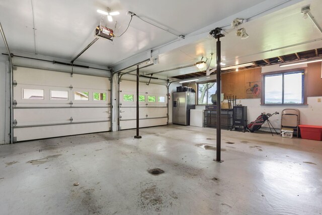 8485 Benson Rd NW, Carroll, OH 43112 - garage featuring stainless steel fridge with ice dispenser and a garage door opener