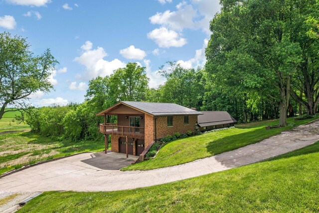 8485 Benson Rd NW, Carroll, OH 43112 - view of front facade featuring driveway, a garage, brick siding, a front yard, and a deck