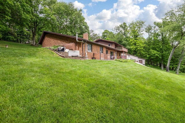 8485 Benson Rd NW, Carroll, OH 43112 - rear view of property featuring a chimney, a lawn, and brick siding