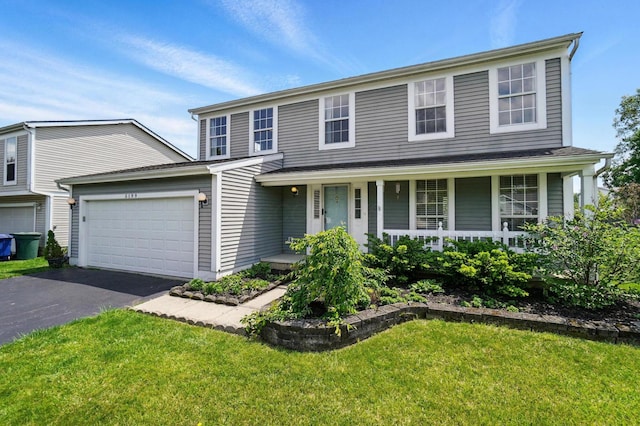 5199 Goldfield Dr, Hilliard, OH 43026 - traditional-style house featuring driveway, a garage, covered porch, and a front lawn