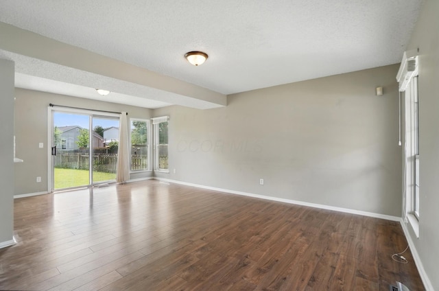 5199 Goldfield Dr, Hilliard, OH 43026 - unfurnished room featuring baseboards, dark wood-type flooring, and a textured ceiling