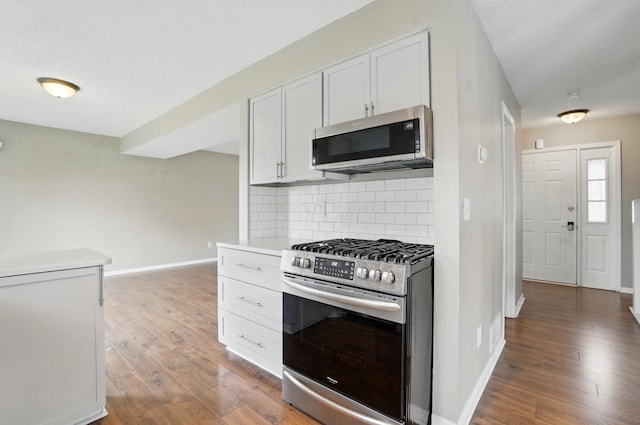 5199 Goldfield Dr, Hilliard, OH 43026 - kitchen featuring appliances with stainless steel finishes, wood finished floors, tasteful backsplash, baseboards, and light countertops