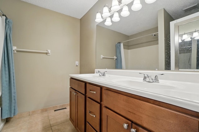 5199 Goldfield Dr, Hilliard, OH 43026 - full bathroom featuring tile patterned flooring, double vanity, a shower with shower curtain, baseboards, and a textured ceiling