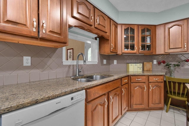 71 Donald Ross Dr, Granville, OH 43023 - kitchen featuring white dishwasher, brown cabinets, and light stone counters
