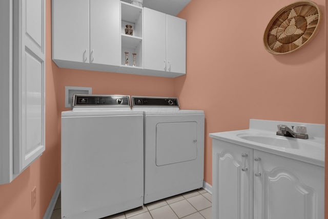 71 Donald Ross Dr, Granville, OH 43023 - laundry area featuring washing machine and dryer, cabinet space, and light tile patterned flooring