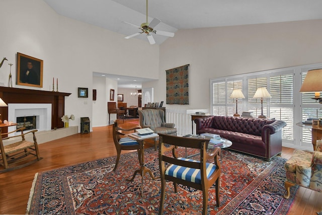 71 Donald Ross Dr, Granville, OH 43023 - living room featuring wood finished floors, high vaulted ceiling, ceiling fan, and a fireplace with raised hearth