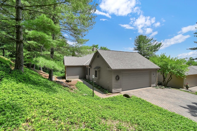 71 Donald Ross Dr, Granville, OH 43023 - view of property exterior with driveway, a garage, and a shingled roof