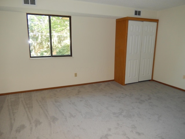 4143 Karl Rd Unit 214, Columbus, OH 43224 - unfurnished bedroom featuring carpet flooring, a closet, and baseboards