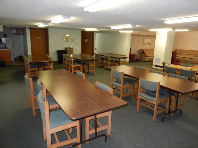 4143 Karl Rd Unit 214, Columbus, OH 43224 - dining area with a textured ceiling and carpet flooring