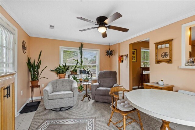 1200 Northridge Rd, Columbus, OH 43224 - living area featuring a ceiling fan, plenty of natural light, crown molding, baseboards, and light tile patterned floors