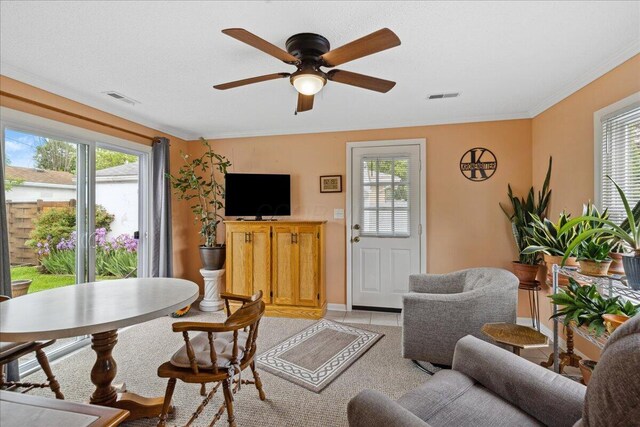 1200 Northridge Rd, Columbus, OH 43224 - living area featuring plenty of natural light, a ceiling fan, baseboards, light colored carpet, and crown molding
