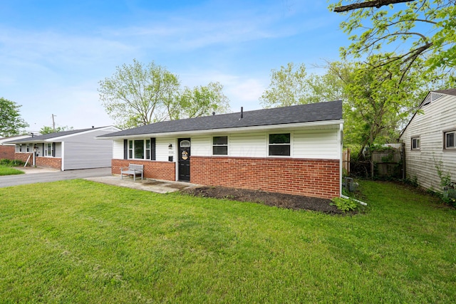 ranch-style home featuring brick siding and a patio