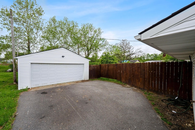detached garage featuring fence