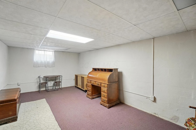 carpeted home office featuring a paneled ceiling