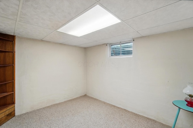 below grade area with carpet and a drop ceiling