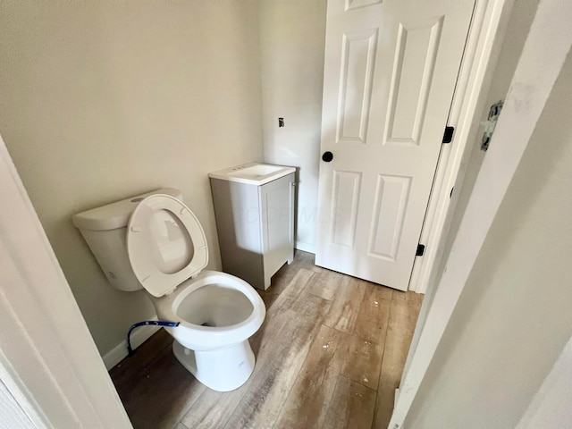 818 Bellows Ave, Columbus, OH 43223 - bathroom with wood finished floors, toilet, and baseboards