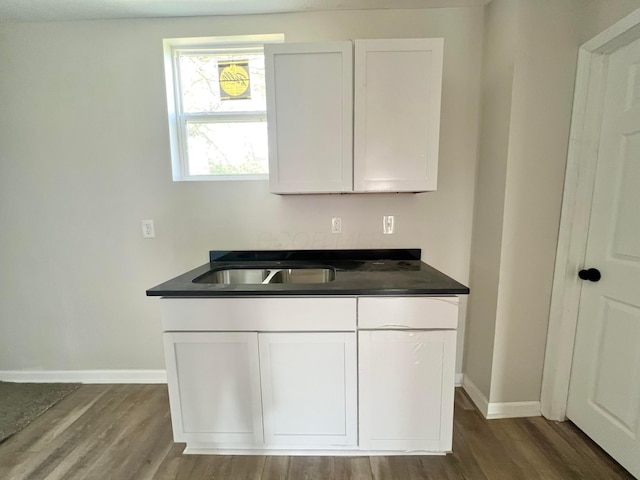 818 Bellows Ave, Columbus, OH 43223 - kitchen featuring baseboards, dark wood-type flooring, a sink, and white cabinets