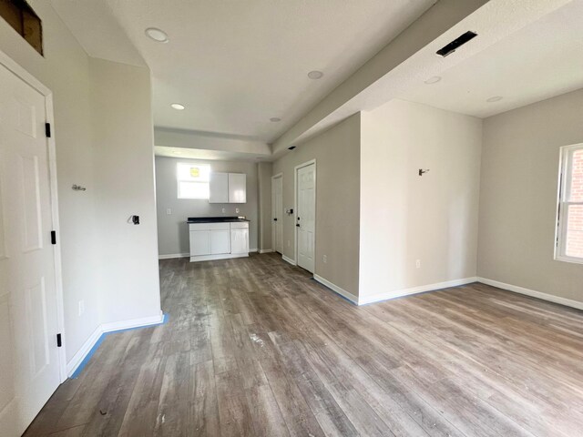 818 Bellows Ave, Columbus, OH 43223 - unfurnished living room with wood finished floors, baseboards, and recessed lighting