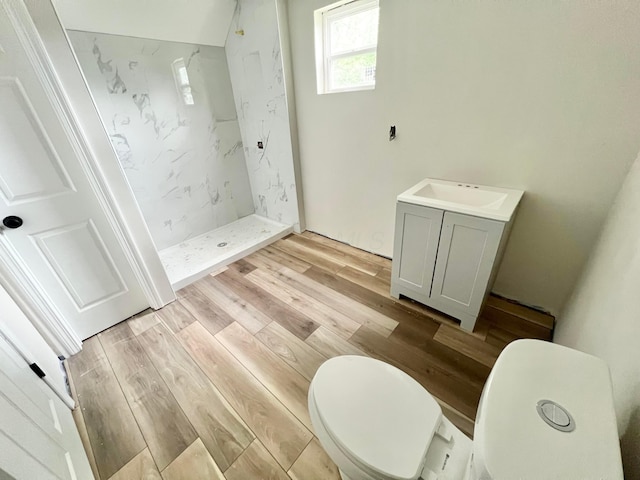 818 Bellows Ave, Columbus, OH 43223 - full bathroom with a stall shower, wood finished floors, vanity, and toilet