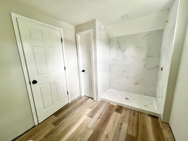 818 Bellows Ave, Columbus, OH 43223 - bathroom featuring a stall shower and wood finished floors