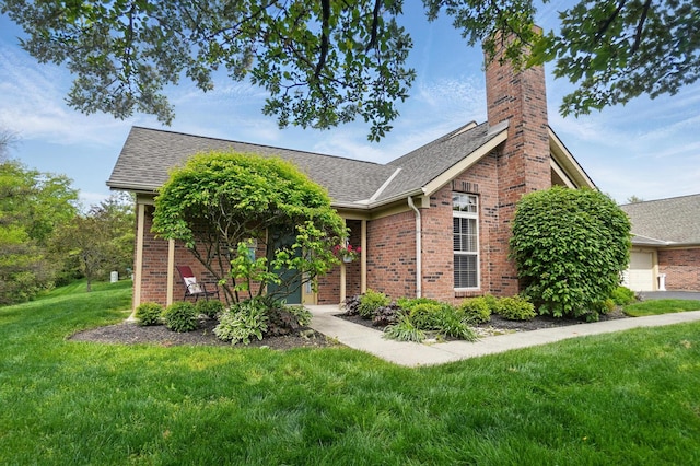 2675 Pine Marsh Dr, Grove City, OH 43123 - view of front facade featuring a front lawn, brick siding, a chimney, and a shingled roof