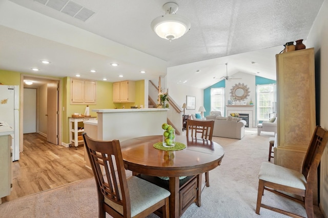 2675 Pine Marsh Dr, Grove City, OH 43123 - dining space featuring stairs, ceiling fan, a fireplace, vaulted ceiling, and baseboards